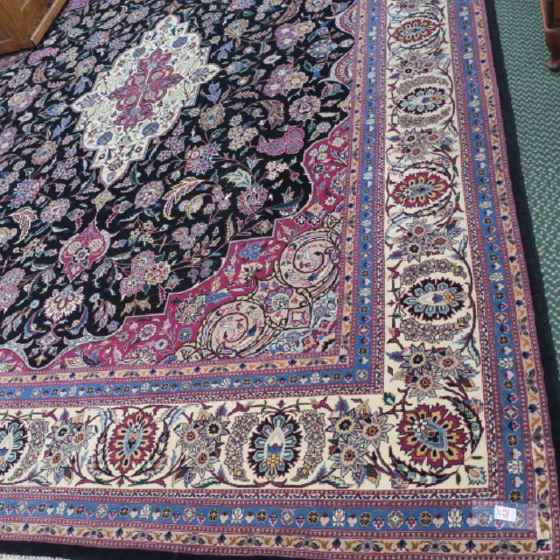 Fine Traditional Pakistan Hand Knotted Wool Rug:: Fine Traditional Pakistan Hand Knotted Wool Rug: Marketed by Trade AM. 7 Banded Border and Guard Stripes Having a Main Band of Mirrored Stylized Florals. Shaped Corner Medallions, Sculpted Black Groun