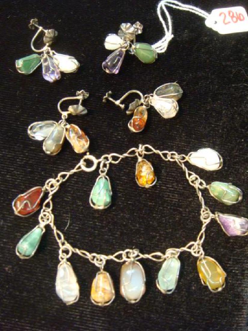 Tumbled Gemstone Bracelet and Earrings:: Tumbled Gemstone Bracelet and Earrings: Circa 1970's. 12 Stone Nugget Charms Wrapped in Wire on 7" Chain Link Bracelet. 2 Pairs of Screw Back Earrings. (100-200)