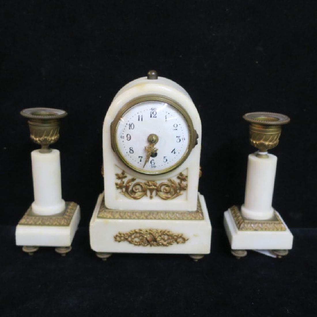 Small Bronze and Marble Clock Garniture Set:: Small Bronze and Marble Clock Garniture Set: Petite Dome Top Clock, Ormolu Mounts, 6 1/2"T. With Pair of Candlesticks having Marble Columns, Brass Caps & Ormolu Mounts. 5"T. 5 T. All pcs. on Brass Fee
