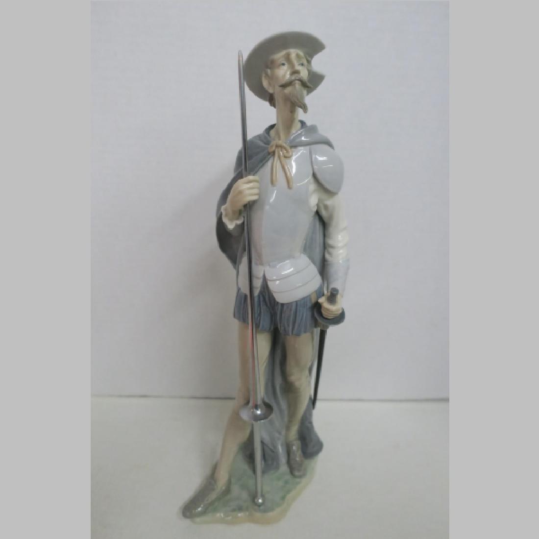 Lladro Don Quixote on Guard #1385:: Lladro Don Quixote on Guard #1385: Issued 1978-87. 15 1/4"T by SALVADOR FURIO Sculptor. Standing Tall with Sword and Lance Dressed in Leggings and Cape. (150-300)