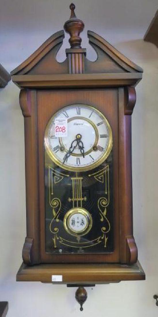 ALARON 31 Day Wall Clock:: ALARON 31 Day Wall Clock: Porcelain Metal Face with Roman Numerals. Strikes on Hour and Half Hour. Can shut Off Chime. Glass Door with Gold Decoration. Needs Work. Has Key and Pendulum. 25"T, 10"W, 5