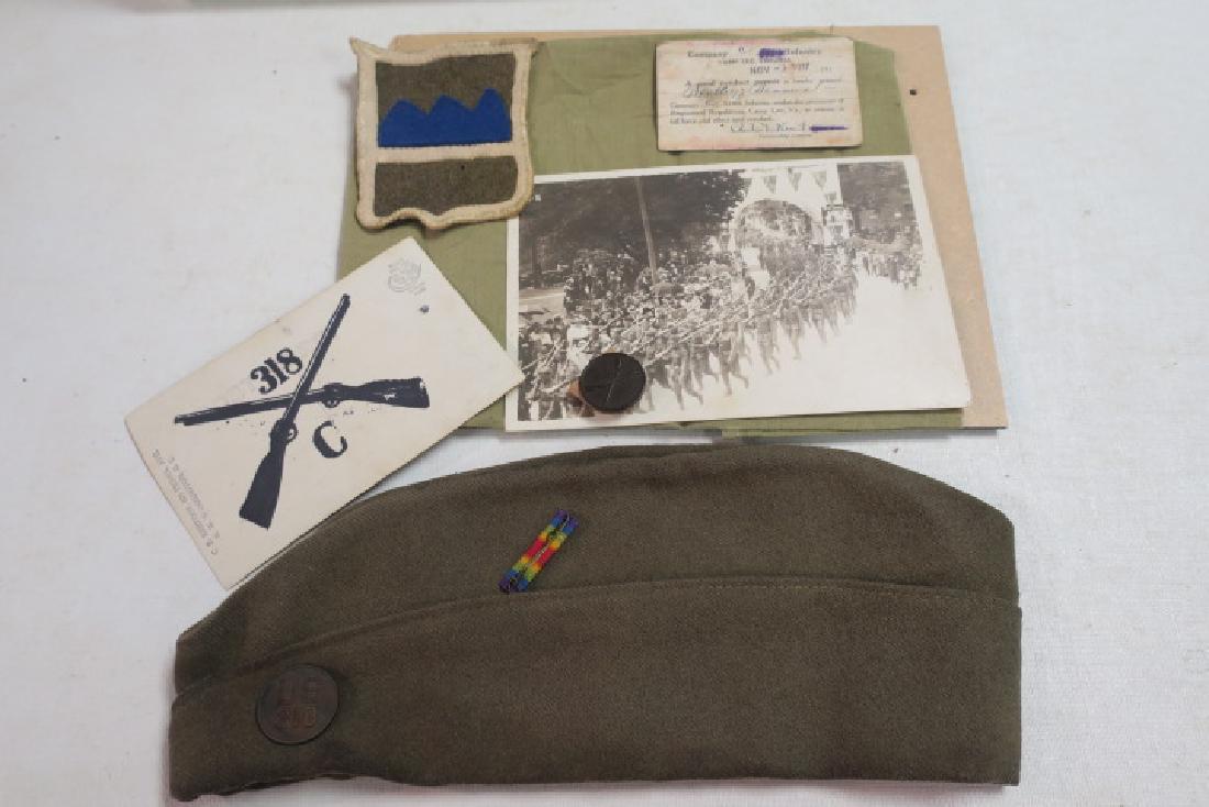 C Company 318 Infantry Regiment Memento Box:: C Company 318 Infantry Regiment Memento Box: Good Conduct Permit Issued to BENTLEY DEAVERS by his CO. Picture of Marching Soldiers, 80th Division Patch Overseas Cap with US 318 Insignia. Infantry Lapi