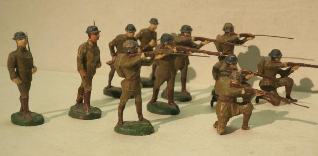 Eleven MADE IN GERMANY Model Toy Soldiers:: Eleven MADE IN GERMANY Model Toy Soldiers: Firing Rifles; Standing and Kneeling, Advancing and Marching. Composition. 3 1/2' tall. (80-150)