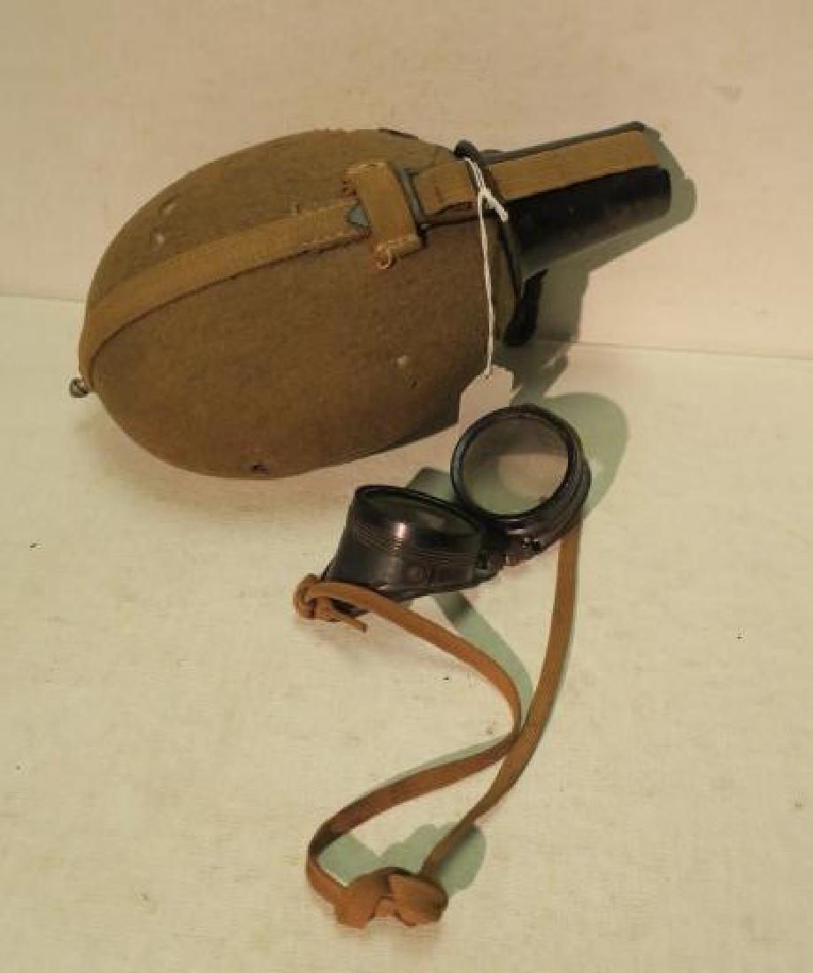AFRIKA KORPS Canteen with Bakelite Cup & Googles:: AFRIKA KORPS Canteen with Bakelite Cup & Googles: Canteen is 11" Long with Few Holes in felt Cover. Bakelite Googles with Glass Lens and Shoe string Back Strap. This Item will be sold On-line Only. (1