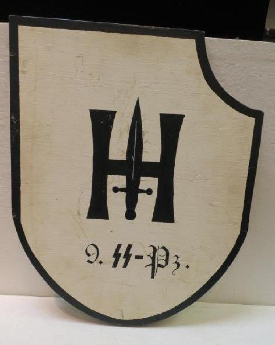 Wooden Headquarters Sign for 9 SS PANZER DIVISION:: Wooden Headquarters Sign for 9 SS PANZER DIVISION: Shield with Divisional Symbol of 9 SS PANZER DIVISION on White Ground outlined in Black. Used to Mark Road outside of Division Headquarters. 20" x 16