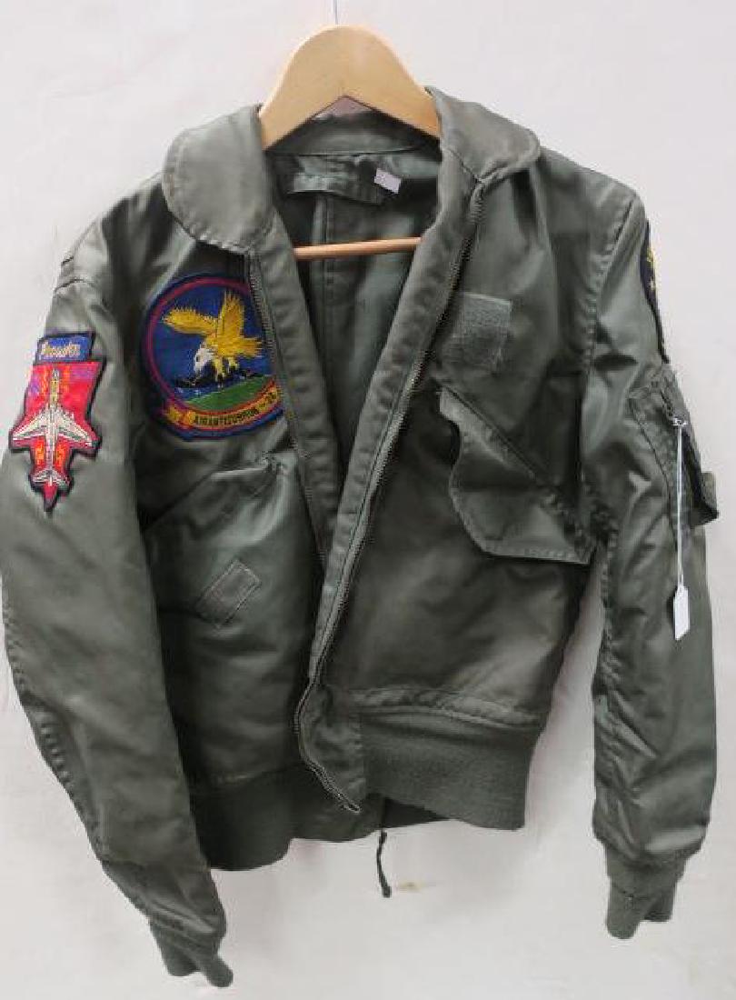 US NAVY Nylon Jet Pilot's Flight Jacket with Patches:: US NAVY Nylon Jet Pilot's Flight Jacket with Patches: JOLLY ROGERS TOMCAT, EA-6B PROWLER, and AIRANTISUBRON-24 Patches on Breast and Sleeves. Velcro Closures on Pockets, Stretch Knit Fabric on Cuffs a