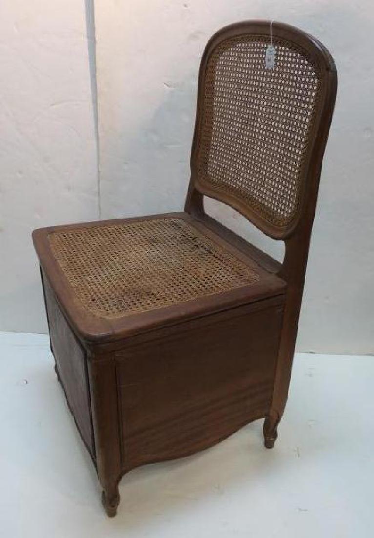 Antique Caned Commode Chair with Lift Seat:: Antique Caned Commode Chair with Lift Seat: Louis XVI Walnut Frame with Shaped Caned Back. Double Caned Seat with Open Compartment Belos. Double Hinged Lid, the Second with Potty Hole. Solid Panels al