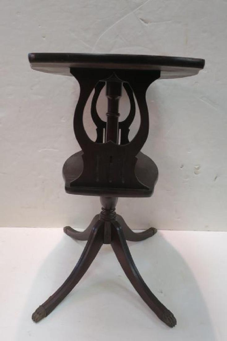Two Tier Mahogany Pedestal Side Table:: Two Tier Mahogany Pedestal Side Table: Shaped 15" X 23" Top Supported but Turned Pedestal and @ Stylized Harps Over 2nd Tier. 4 Splayed Legs with Brass Cap Paw Feet. 24 1/2"T (60-120)