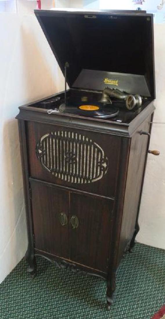 Antique BRUNSWICK Floor Model Record Player:: Antique BRUNSWICK Floor Model Record Player: Mahogany Cabinet with Ogee Shaped Lift Top. Brunswick Decal Under Lid. Spring Driven Turntable with Crank & Speed Regulator. Comes with Collection Pink Che