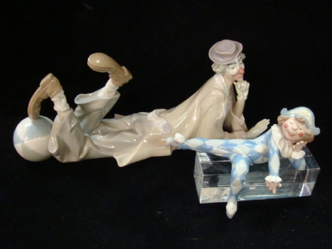 Two LLADRO Clown Figurines:: Two LLADRO Clown Figurines: Reclining Clown #4618 Sculpted by Salvador Furio, 1970 Retired 1991. 6 1/4"T, 14 1/2"L. Shelf Sitter Clown #1503 is 7 1/4"L. Made to Sit on Edge of Shelf with Leg Hanging O