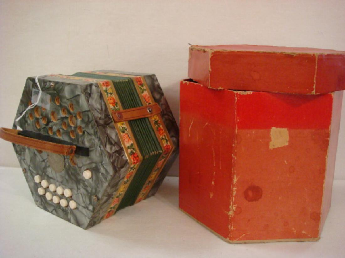 Vintage SCHOLER Concertina or Squeeze Box:: Vintage SCHOLER Concertina or Squeeze Box: 1940's. Has Original Hexagonal Box with Lid. Made in Germany, Green Edges. Silver Marbled Ends, Leather Straps (One Needs Reattaching). Flower Borders. Worki