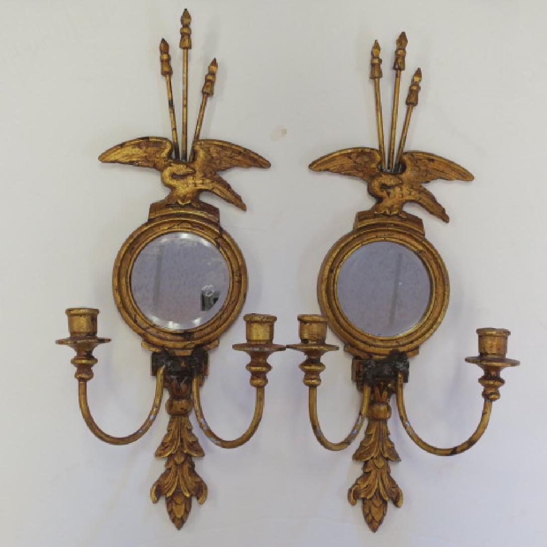 Pair of Metal Federalist Candle Sconces with Mirrors:: Pair of Metal Federalist Candle Sconces with Mirrors: Double Arms with Eagle Crest Holding 3 Arrows and Round Mirror. Brushed Venetian Gold Coloration. 27"L. Some Flaking. (100-200)