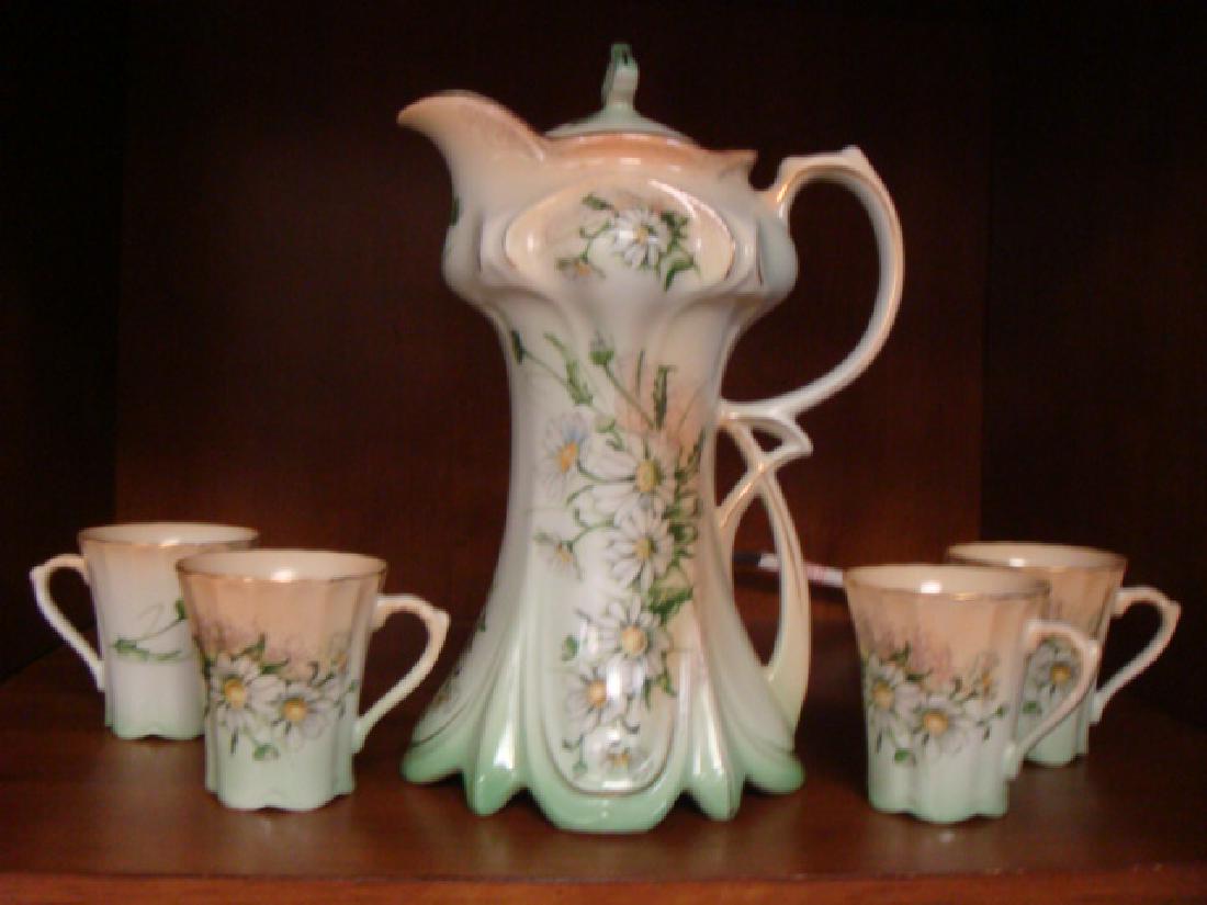 Five Pc. Chocolate Set Marked Limoges China:: Five Pc. Chocolate Set Marked Limoges China: Lidded Pot with 4 Handled Cups, Each with Hand Painted Daisies on Ground of Pastel Pink shading to Green. Double Opening Applied handle. (100-250)