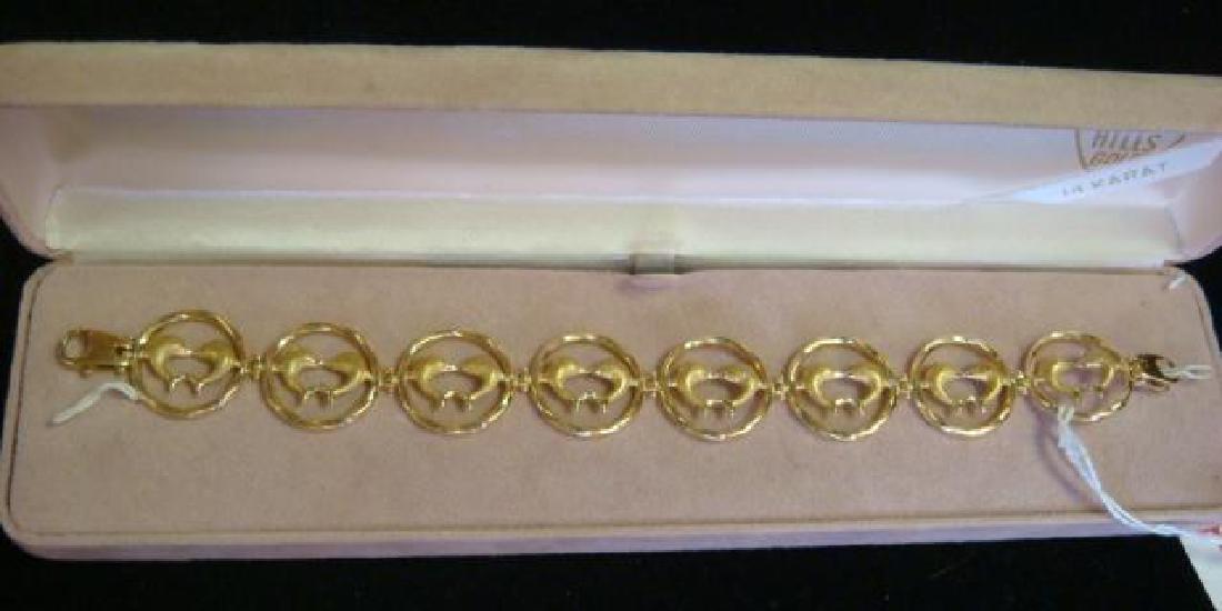 18KT Yellow Gold Bracelet with Dolphins:: 18KT Yellow Gold Bracelet with Dolphins: Eight Link Circles have Leaping Dolphins Touching Noses Inside Each Ring. 7"L with Lobster Claw Clasp. Marked 750 Italy Which Indicates 18KT Gold. (-)