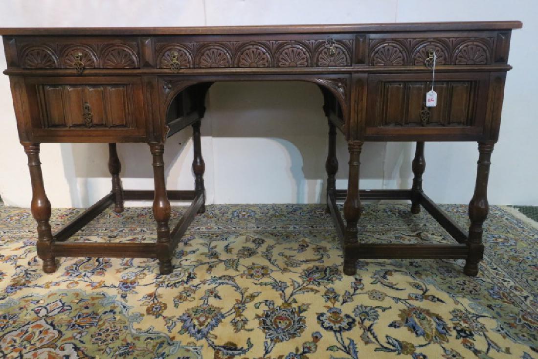 KITTINGER Renaissance Style Walnut Five Drawer Desk:: KITTINGER Renaissance Style Walnut Five Drawer Desk: Carved on Drawer Fronts and on Back. Turned Legs with Box Stretchers. Line Carved Top. Paneled Sides. 30"T, 26 1/2" X 57". Metal Kittinger Tag in D