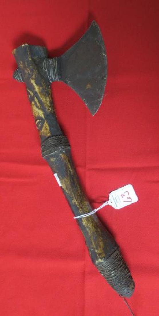 African War Axe with Face Carving on Shaft:: African War Axe with Face Carving on Shaft: Carve Faces on Shaft of War axe with String Wrapping. Great patina from Wear. 5" Axe Face Wedged into Shaft Reinforced with Wire Wrapping. (100-300)