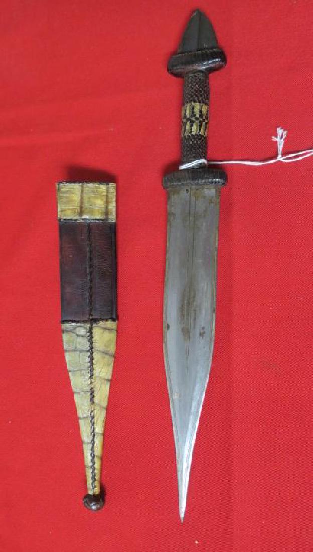 SUDAN ARM DAGGER with Snake Skin Sheath: SUDAN ARM DAGGER with Snake Skin Sheath Central Africa Produces these Stabbing Stiletto Type Knife for a Thousand Years. Skull Cracker Pommel, Leather and Snake Skin Grip Section, 9" Blade. Leather Sh