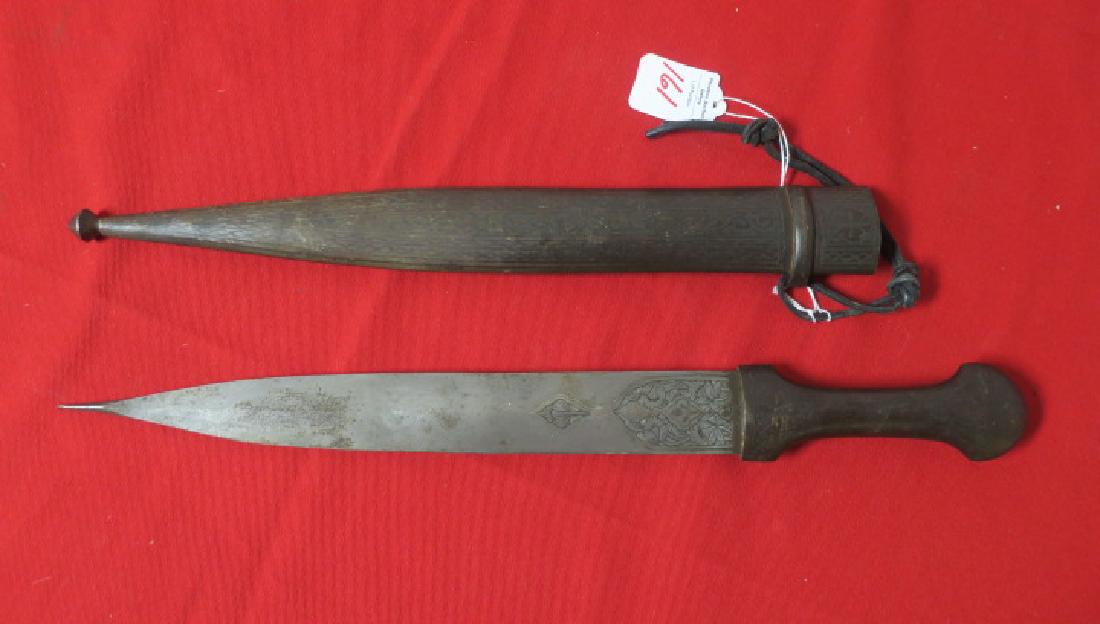 LONG DOUBLE EDGED KNIFE in METAL SCABBARD:: LONG DOUBLE EDGED KNIFE in METAL SCABBARD: 11 3/4" Floral Engraved Blade with Reinforced Tip. Embossed Matched Metal Scabbard, Grips and Pommel. 19" LOA. Excellent Condition (150-300)
