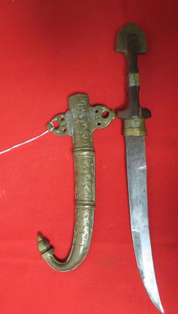 ARAB JANBIYYA with Brass Scabbard and Decoration.: ARAB JANBIYYA with Brass Scabbard and Decoration. 9 1/2" Curved Blade with Wooden Handle with Cast Brass Pommel. Brass Embossed Scabbard with Islamic Designs and two Hangers. Curved Tip. 15" LOA. (70-