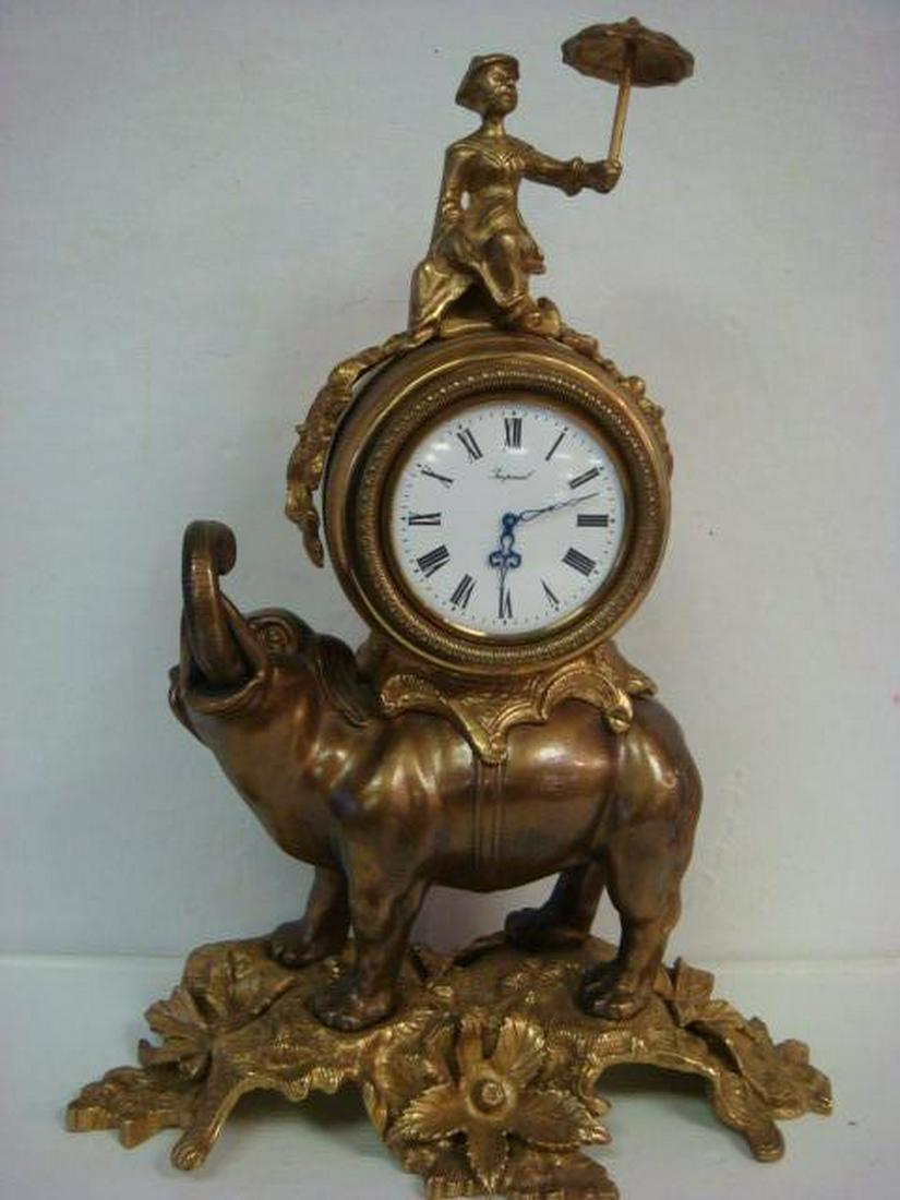 Bronze Elephant Mantel Clock Marked Brevettato:: Bronze Elephant Mantel Clock Marked Brevettato: Set Key Wind Movement. Porcelain Dial. 8 Day Clock Set on Elephants Back, Howdah Style, The Elephant Stands on Leaves and Flowers. Ridden by Man in Hat 