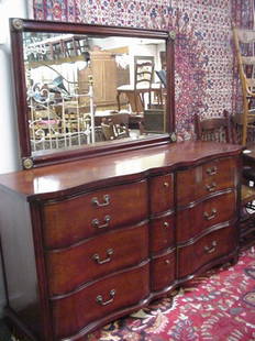 Mahogany Double Serpentine Dresser & Mir: Mahogany Double Serpentine Dresser & Mirror: Double Serpentine Front with 3 Small Stacked Center Drawers Flanked by 3 Larger Drawers, Top Drawer Having Faux Divided Front. Metal Hardware. Ogee