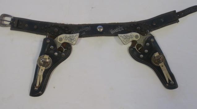 HOPALONG CASSIDY Cap Guns in Leather Holster/Belt:: HOPALONG CASSIDY Cap Guns in Leather Holster/Belt: 1950's Cap Guns from Wyandotte Featuring a Sketch of Hoppy on Each Side of the Grips. Includes Double Leather Holsters and Steer Head Conchos. Guns a