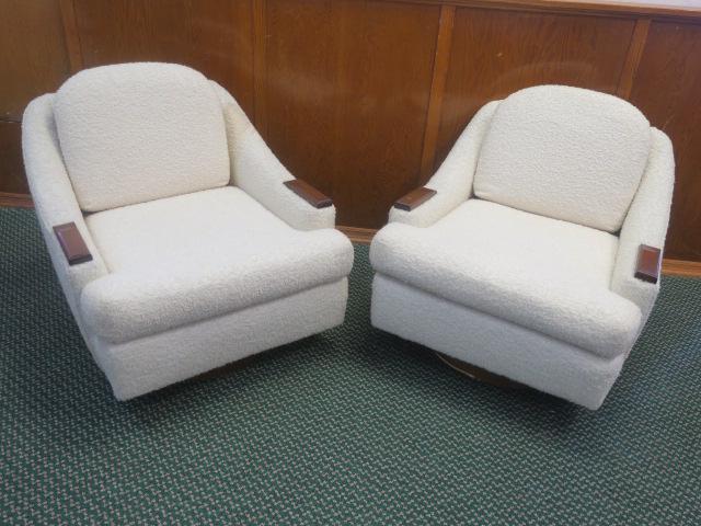 Pair of Off White Boucle Upholstered Swivel Chairs:: Pair of Off White Boucle Upholstered Swivel Chairs: Comfortable Arm Chair with Silhouette of Contemporary Seating. Set on Swivel Mechanism. 360 Degree Swivel, Does not Tilt. Down swept Arms with Accen