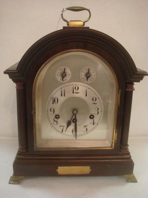 Antique Arched Top German Bracket Shelf Clock:: Antique Arched Top German Bracket Shelf Clock: Mantle Clock has Key and Pendulum. Brass Handle and 4 Bracket Feet. Beveled Glass Front Door with Brass Bezel Opens to Silvered Face with Black Hands and