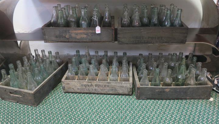 Five Crates of Assorted Vintage Bottles:: Five Crates of Assorted Vintage Bottles: Wooden Crates Hold an Assortment of Glass Soda Bottles Such as Indian Rock, Taka-Kola, Whistle, Julo, Soda Water from Coca-Cola Bottling, Chero-Cola, King-Cola