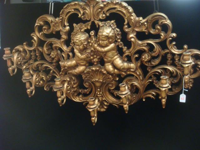 Seven Arm Gilt Painted Sconce with Pair of Cherubs:: Seven Arm Gilt Painted Sconce with Pair of Cherubs: Wall Plaque Has 2 Relief Cherubs in Center w/Grapes Surrounded by Swirls of Acanthus Leaves and Flower Heads. Michigan Company, 1924-1977, Decorativ