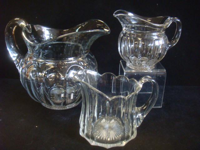 Three HEISEY Colonial Clear Crystal Pitchers:: Three HEISEY Colonial Clear Crystal Pitchers: Include Large 8 1/2"T Handled Clear Pitcher, a smaller 5" Version of the same, and another 5" Colonial Panel Handled Pitcher. (see Pictures) Star Bottoms,