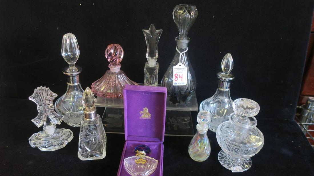 Ten Assorted Large and Small Perfume Bottles:: Ten Assorted Large and Small Perfume Bottles: Pair of Cut Glass Bottles with Silver Collars, Non Matching Stoppers. Triangular Cut Bottle with Silver Collar, Pink Glass Bottle, Cut Crystal Footed Bott