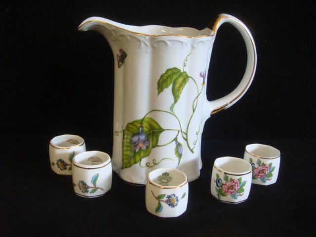 I. GOLDRINGER Pitcher and Five AYNSLEY Napkin Rings:: I. GOLDRINGER Pitcher and Five AYNSLEY Napkin Rings: White Ground Pitcher, 7 3/4" Tall with Butterfly and Ladybug Decorations. Napkin Rings are Flowered Pembroke Pattern. (50-100)