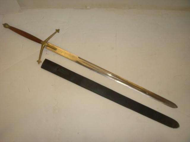 Replica CIAIDHEAMH MOR or CLAYMORE Broad Sword:: Replica CIAIDHEAMH MOR or CLAYMORE Broad Sword: Brass Skull Cracker Pommel over Polished Wood Handle and Brass St Peters Cross Hilt. 39" Double Edged Blade with Long Blood Grove. Leather Scabbard, Mad