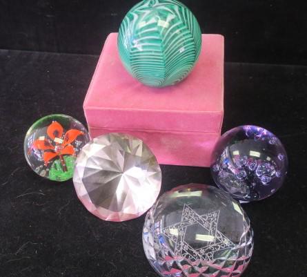 Five Art Glass Paperweights:: Five Art Glass Paperweights: Crystal Flat Bottom Dome with Etched Star of David is 3 5/8"D. Purple 2 3/4"T Ball with Bubbles has Made in Sweden Sticker. Clear 2 1/2"T with Orange Flower and Controlled