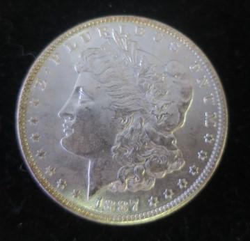 1887 US MORGAN SILVER D0LLAR, MS 64, 90% Pure Silver:: 1887 US MORGAN SILVER D0LLAR, MS 64, 90% Pure Silver: Excellent Example of the Most Collectable of American Silver Coins. Good Eye Appeal and Attractive Luster. The Model for the coin, Anna Williams L