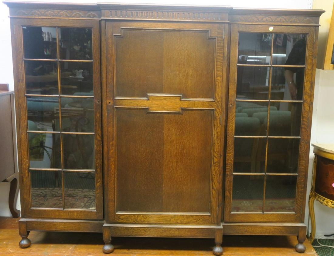 Large 19th C. English Oak Breakfront/Library Cabinet:: Large 19th C. English Oak Breakfront/Library Cabinet: Flat Cornice over Narrow Carved Band. Side Glazed Cabinets each with 10 Individual Panes. Interior Shelves. Center Cabinet is a Mystery. No Key as