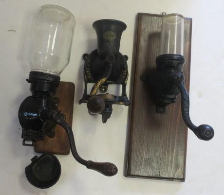 Three Antique Coffee Grinders:: Three Antique Coffee Grinders: Two with Glass Tops and Cast Iron Works, Both on Wall Mount Boards. One with Separate Catch Cup. Both in Very Good Condition. Third Grinder is Sponge & Co., London No.1.