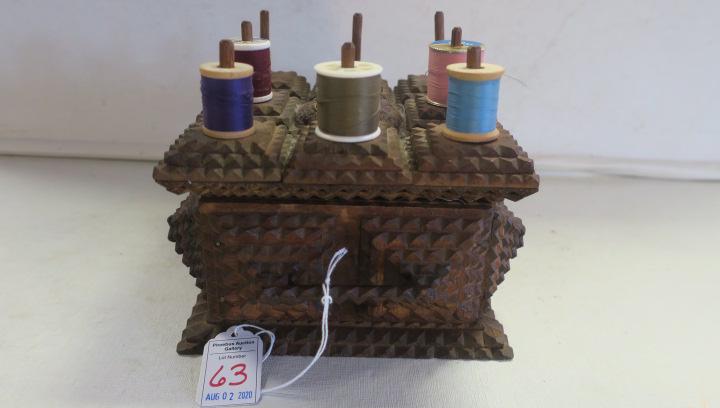 Tramp Art Chip Carved Spool Sewing Box:: Tramp Art Chip Carved Spool Sewing Box: Top of Box has Center Pincushion with Eight Spool Holders,. Front Drawer Opens to Two Sided Compartments. Made From Cigar Boxes. 4 1/4"T, 6 1/2" X 6 3/4". (150-