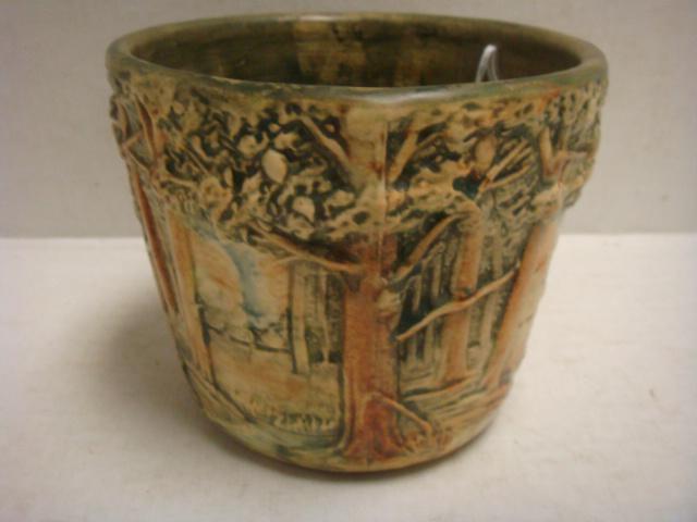 WELLER "Forest" 4 1/2" Jardini?re:: WELLER "Forest" 4 1/2" Jardini?re: CA. 1915-28. Impressed Weller on Bottom. Relief Trees in Green and Brown Matte Glaze. 5 1/2"D at Top. Old Fracture Along Bottom Edge. (100-200)