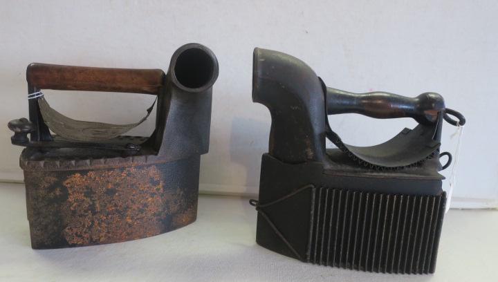 Two Antique Cast Iron Coal Burning Sad Irons:: Two Antique Cast Iron Coal Burning Sad Irons: One has Knob that Turns to Open Top to Add Coal. Copper Heat Guard with Embossed H under Crown in Circle. Viking Hole Cover on Back. Side Chimney. 8 1/2"T