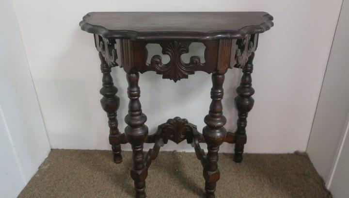 Antique Demilune Carved Hallway Accent Table:: Antique Demilune Carved Hallway Accent Table: Turtle Top over Open Carved Apron with "C" Scrolling. Turned Legs Braced by Carved Cross Stretcher. Rests on Ball Feet. Dark Walnut. 24 1/2"T, 26"W X 12 1