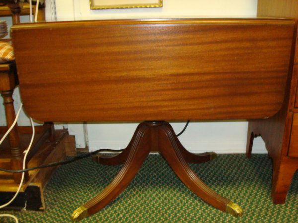 BRANDT Mahogany Drop Leaf Table with Brass Cap Fee: 982. BRANDT Mahogany Drop Leaf Table with Brass Cap Feet: 36"L X 18"D with 13" Drop, 29"T. Center Pedestal with 4 Splayed Line Carved Legs.