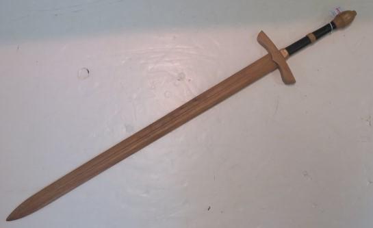 Wooden Medieval Practice Long Sword:: Wooden Medieval Practice Long Sword: Black Painted Handle with Sugar Loaf Pommel and Cross Hilt. Double Edged Blade is 35" Long with Blood Groove, 46" LOA. Very Good Condition. (100-200)