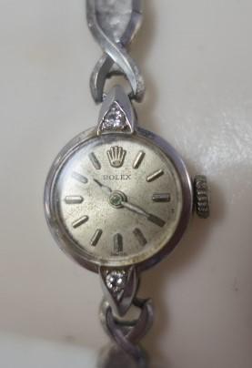 Vintage ROLEX Ladies Watch with Diamonds:: Vintage ROLEX Ladies Watch with Diamonds: 9/16" Face with Crown and Rolex at Top. Diamond at Top and Bottom. Back with Crown and 196256. Tests 10Kt White Gold. Speidel Stretch Band also Tests 10Kt. Wo