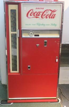 Upright 1960's Coca Cola Machine:: Upright 1960's Coca Cola Machine: Front Door opens to reveal 12 Stand of Pull Out Coke Bottles. Machine Hold Approximately 115 10 Oz Bottles. With Coin Accepter/Changer. Compressor and Refrigerator Wo