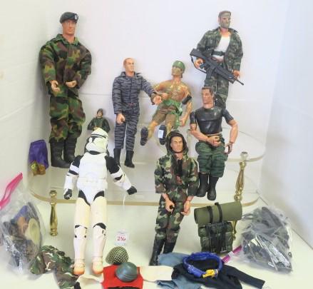 Assorted GI Joes, Storm Trooper and More:: Assorted GI Joes, Storm Trooper and More: Four 12"T 1990's Hasbro GI Joes, 12"T Power Team Action Figure, 15" Place Military Action Figure, 6"T Figure and 12"T Hasbro 2002 Storm Trooper. Includes Bag 