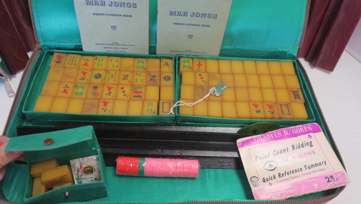 Vintage Mahjong Set in Vinyl Case:: Vintage MahJong Set in Vinyl Case: Bakelite Tiles with Both Bakelite and Wooden Tile Stands. Separate Cases Hold Dice and Chips. Brown Vinyl Case with Lock and Keys. 2 Booklets of Wright-Patterson AFB