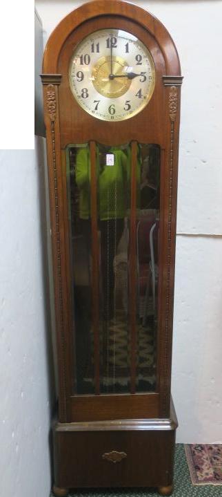 Deco Style CA 1930's Grandfather Clock:: Deco Style CA 1930's Grandfather Clock: Arch Top Mahogany Case with Applied Carved Florals and Egg & Dart Down Sides of Glass Door. Weight Driven. Brass and Silvered Metal Face with Black Arabic Numer