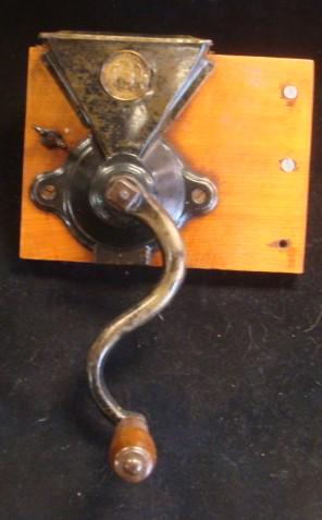 Antique Charles Parker Coffee Bean Grinder:: Antique Charles Parker Coffee Bean Grinder: Cast Iron Grinder, Tin Hopper with Hinged Lid. Wall Mounted on Board. Good Condition for Age. Moving Parts Working. Eagle Coin Embedded in Hopper. (100-200)